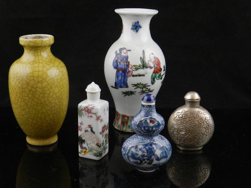 Two Chinese porcelain snuff bottles, a silvered Chinese snuff bottle, a ceramic crackle glaze