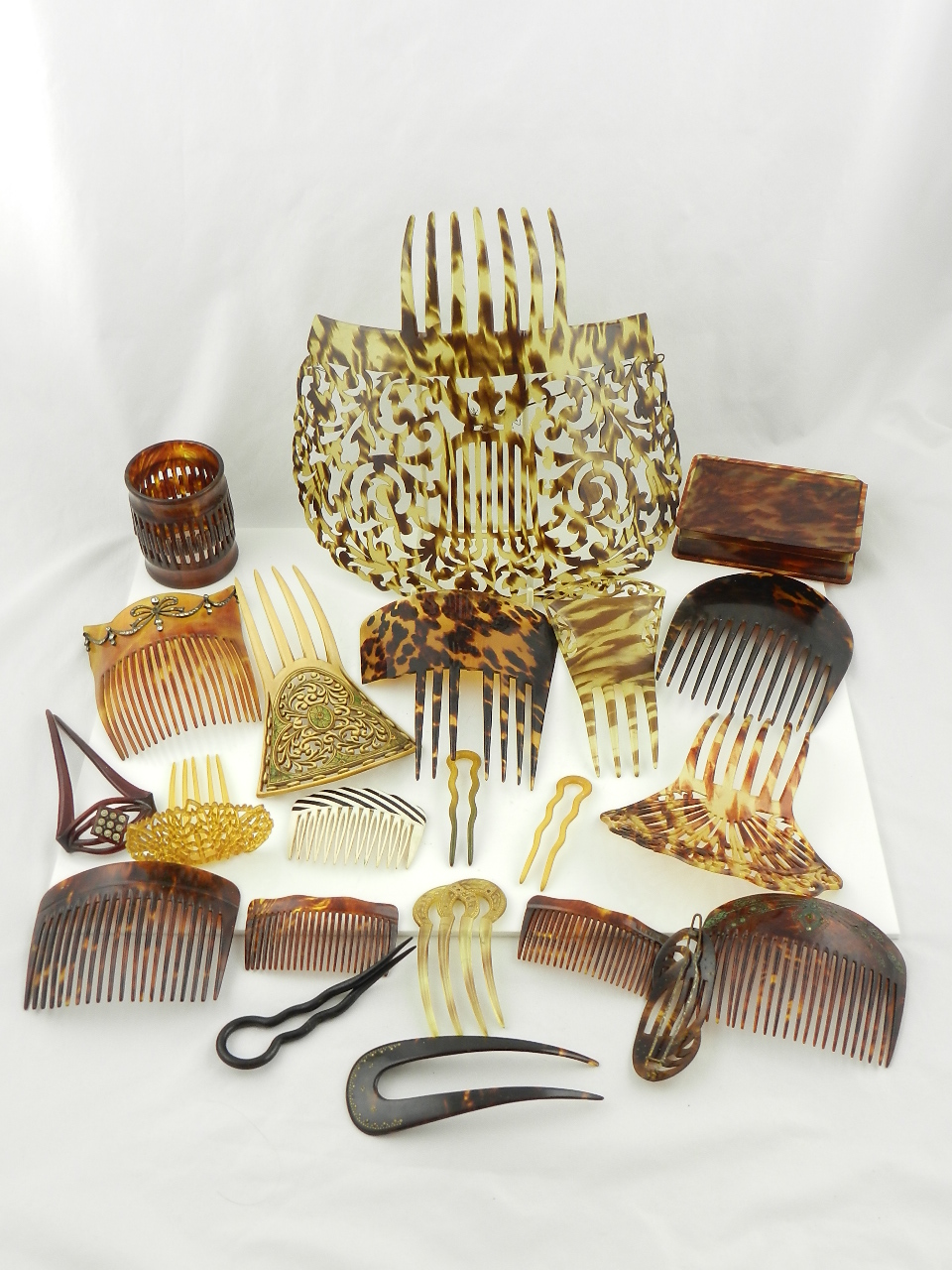 A collection of Spanish peineta hair combs and other related items.