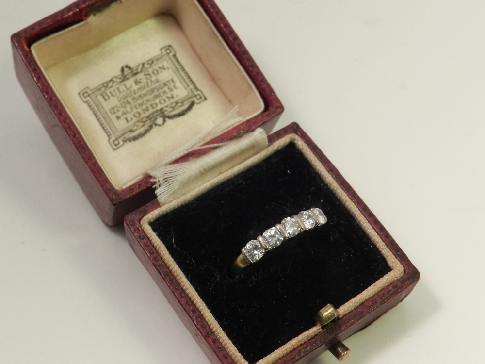 An 18ct gold and platinum mounted five stone diamond dress ring.