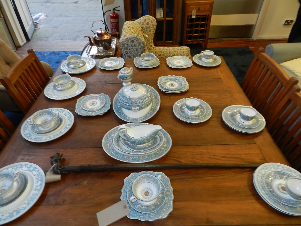 A Wedgwood porcelain dinner service, decorated with a classical frieze.