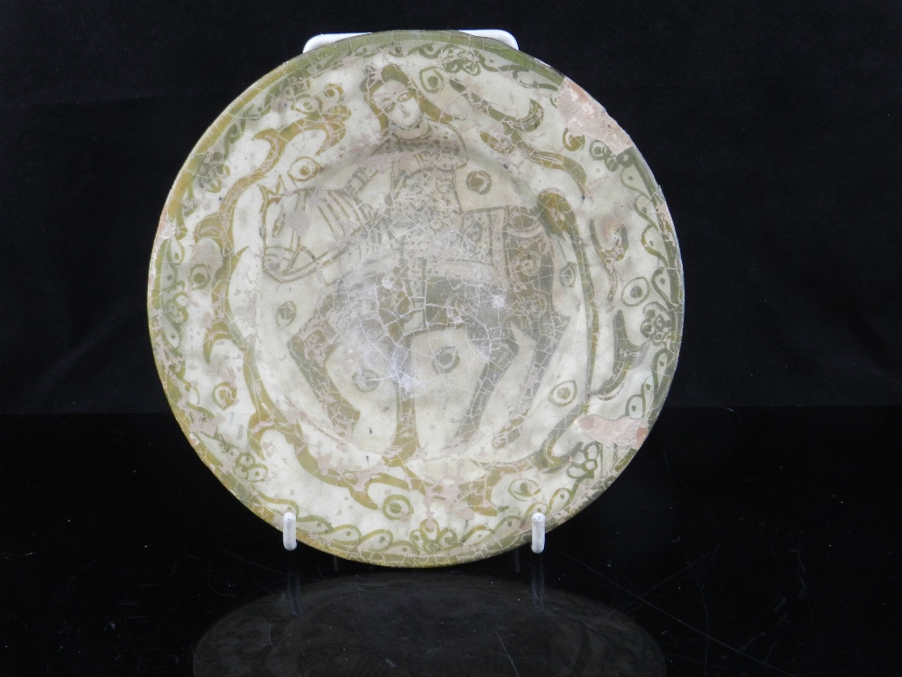 A Persian Kersham plate, circular with everted sides, the centre decorated with a figure on