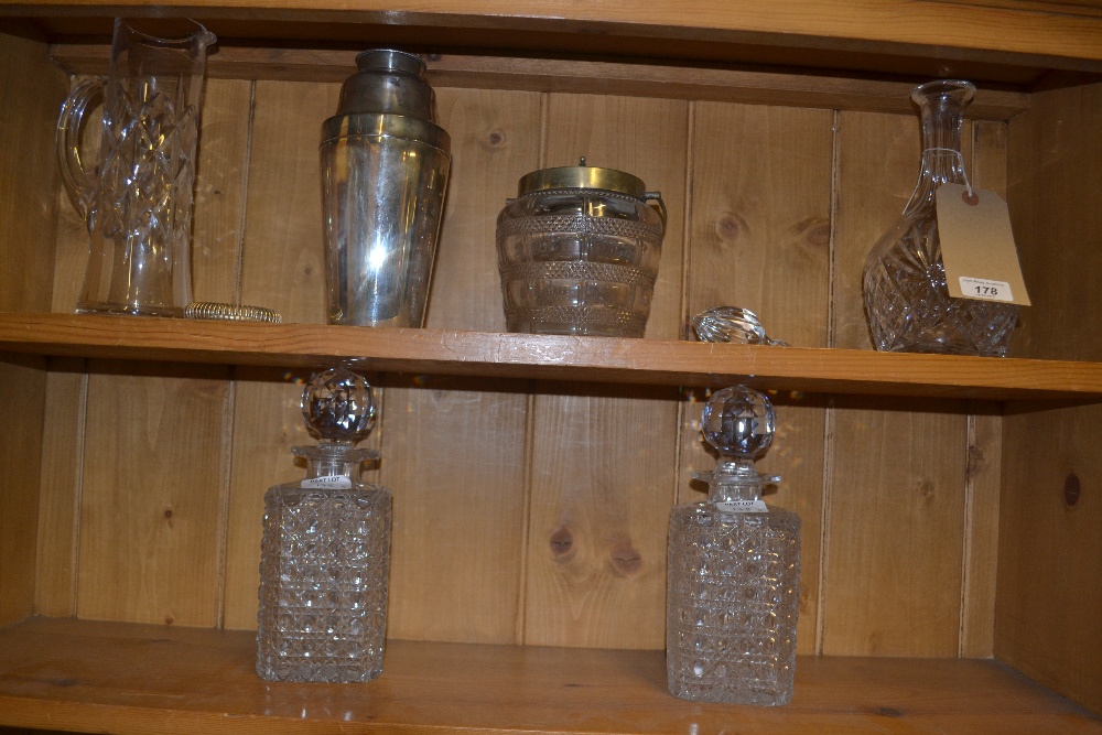 A pair of hobnail cut crystal glass decanters and one other, a silver plated cocktail shaker, a
