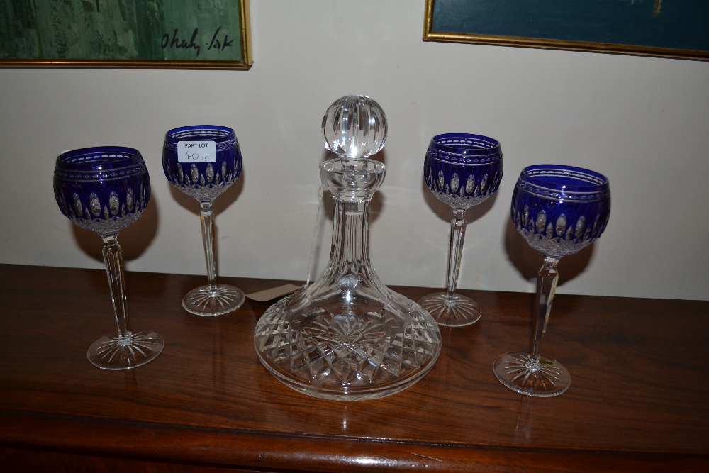 A Waterford cut glass ships decanter, together with a set of four Waterford blue glass overlaid