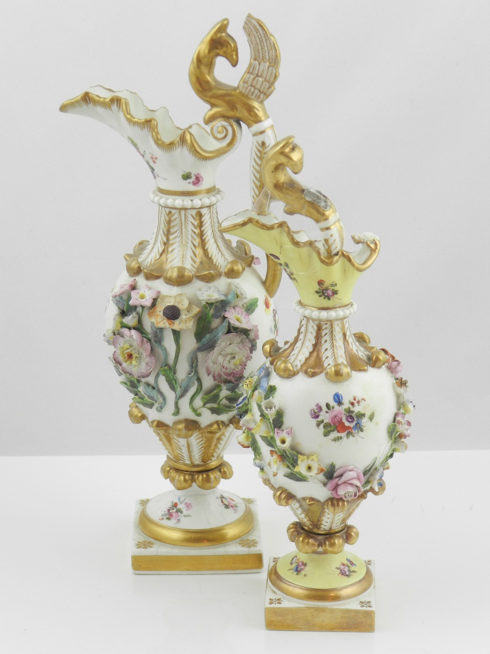 Two Davenport ewers, encrusted with flowers and floral swags with gilt acanthus leaves to neck,