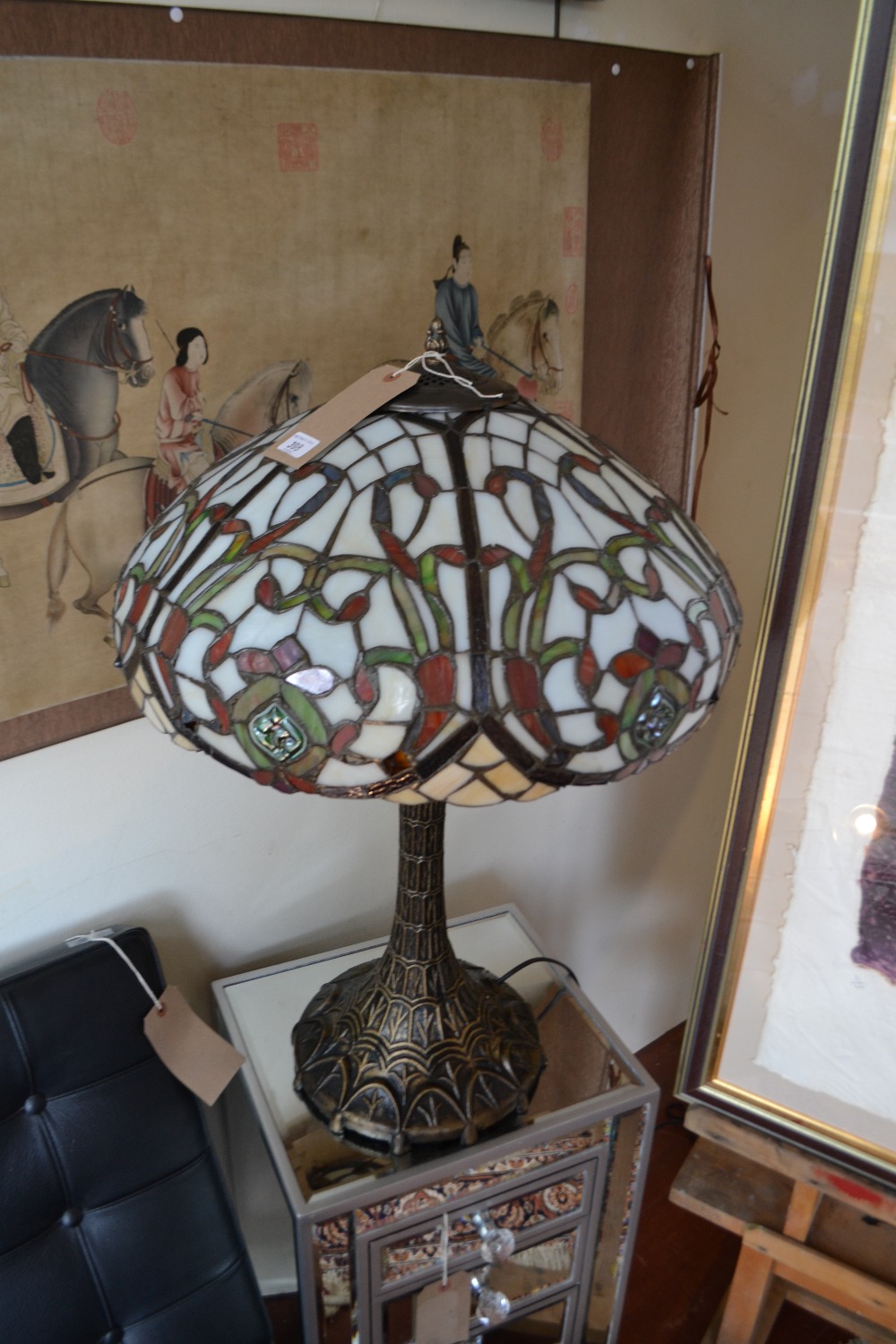 A large Tiffany style leaded stained glass table lamp, bronze base. H. 28".