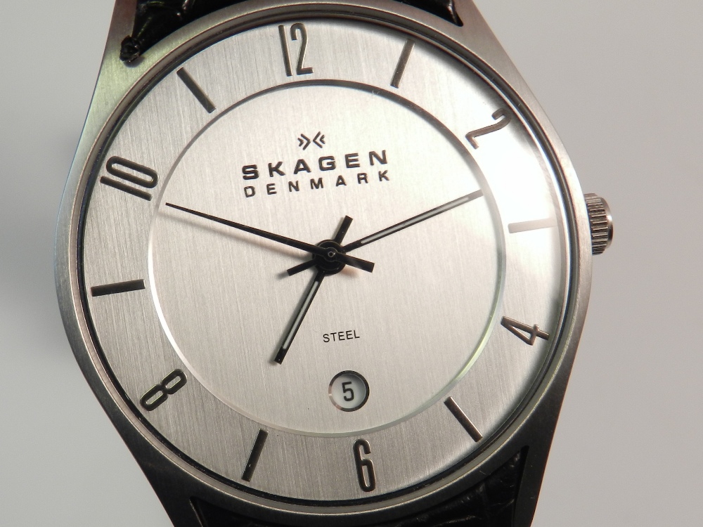 Skagen, Denmark. A gentlemen's stainless steel wristwatch with black leather strap, boxed.