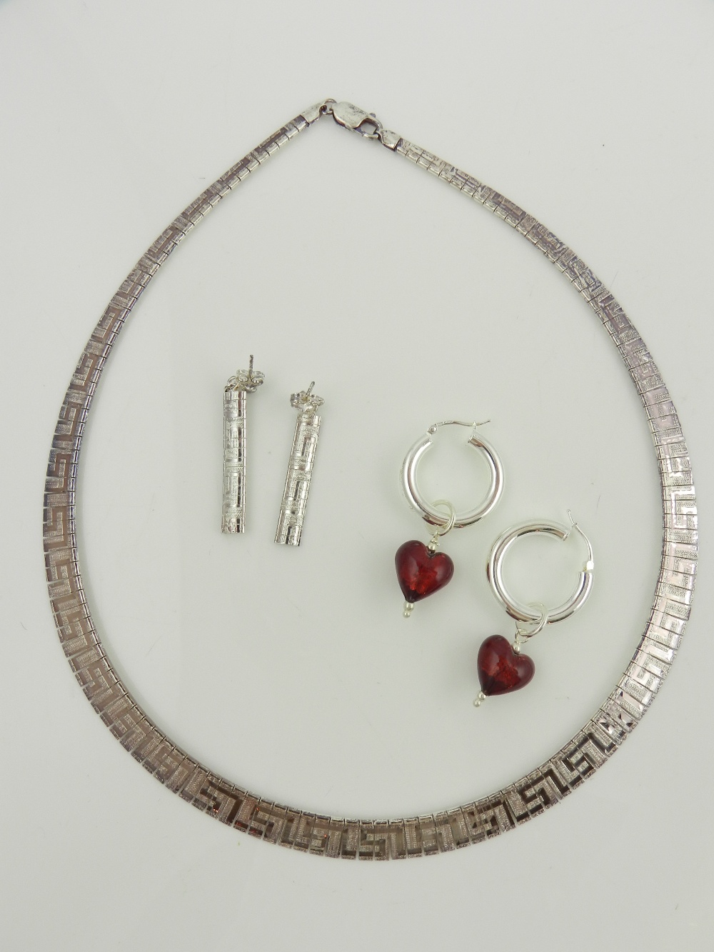 A cased silver necklace, reticulated and decorated with Greek key pattern together with matching