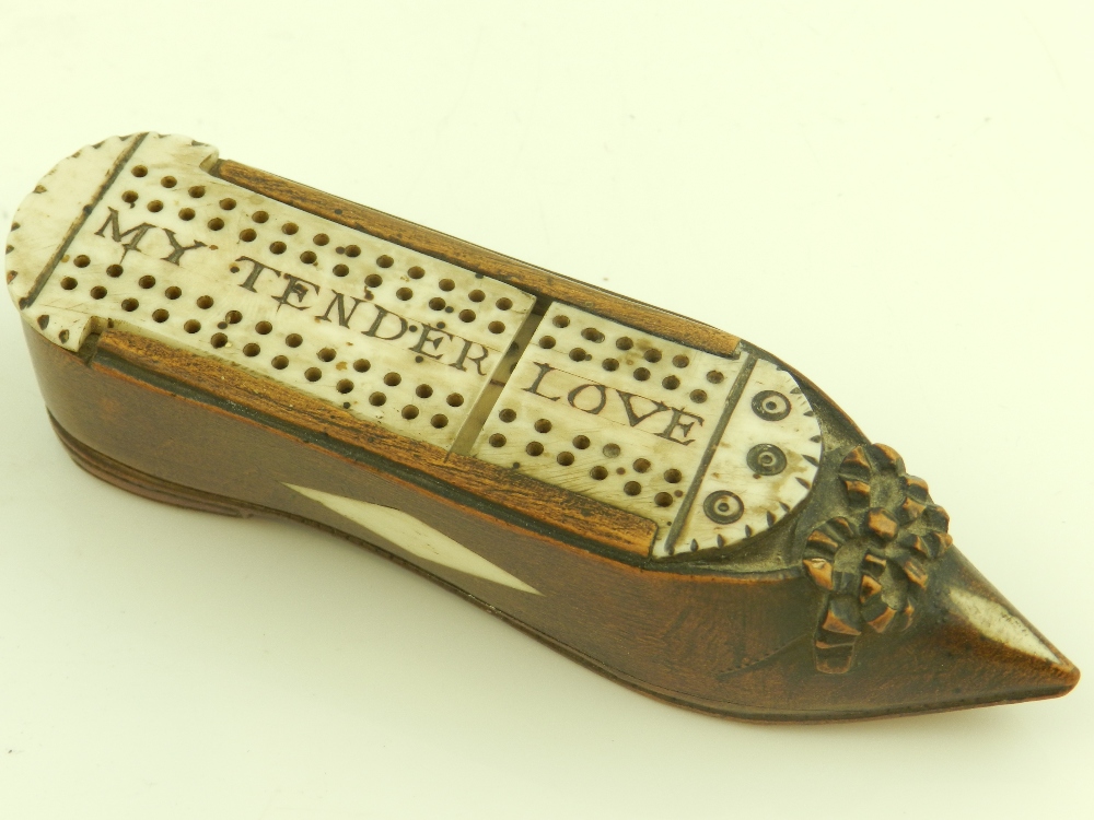 A 19th century dominoes set, in a shoe shaped case set with bone detail and with sliding top.