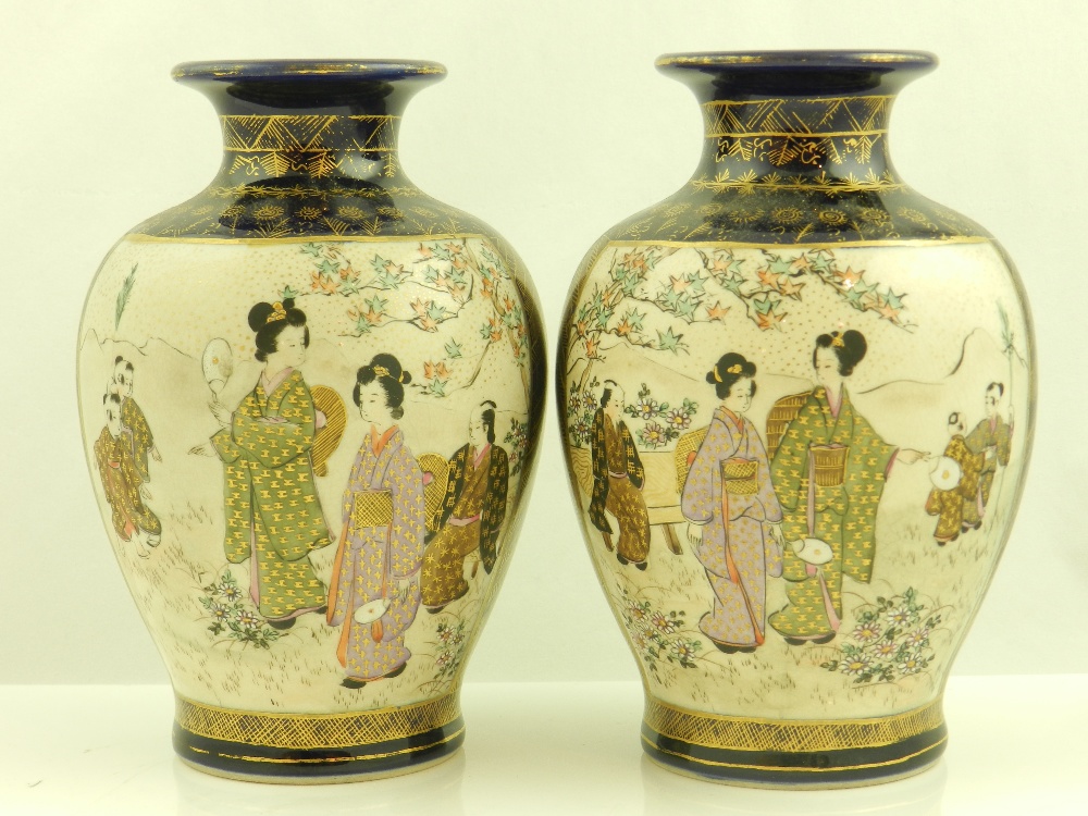 A pair of Japanese Satsuma ovoid vases, decorated with courtesans in gardens.