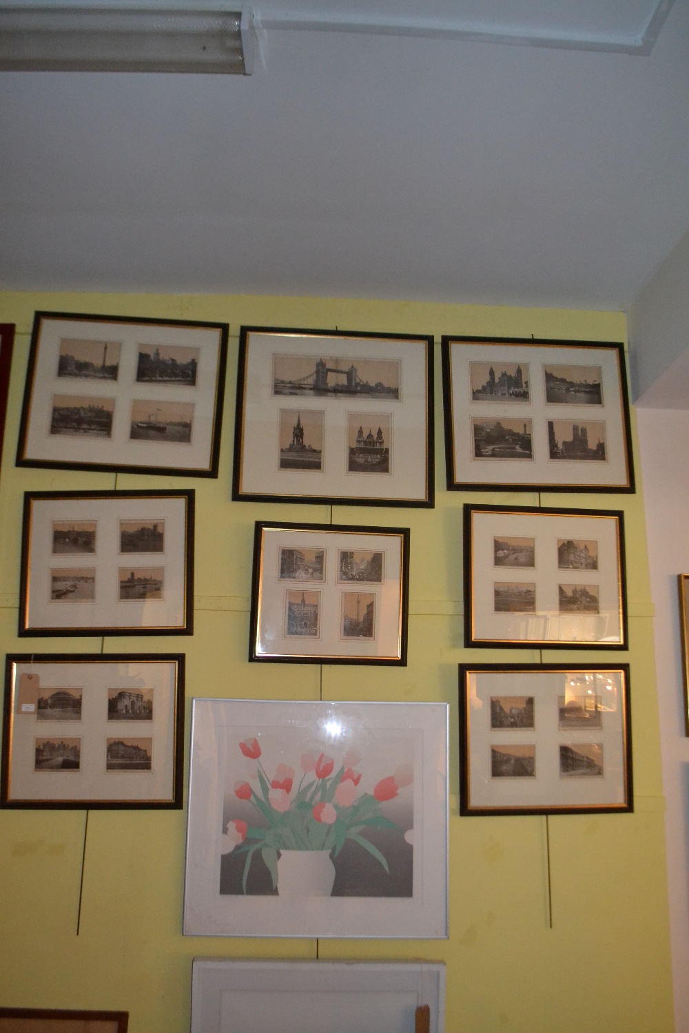 Eight framed and mounted examples displaying several monochrome pictures of London.