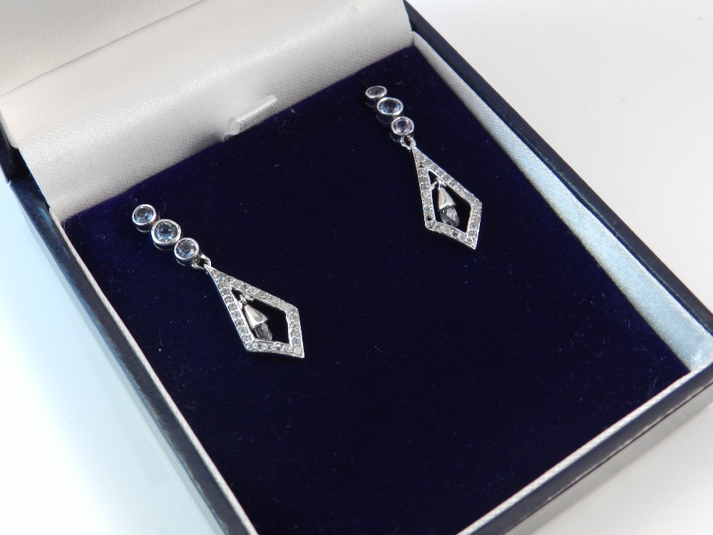 A pair of Art Deco style white metal, sapphire and diamond set drop earrings of lozenge form (