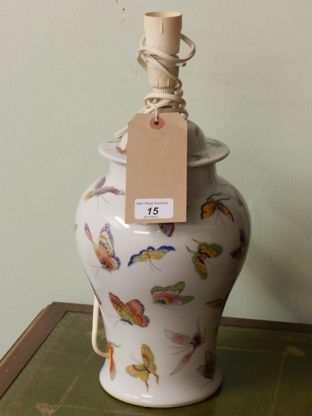 A Chinese porcelain vase and cover lamp base, decorated with butterflies.