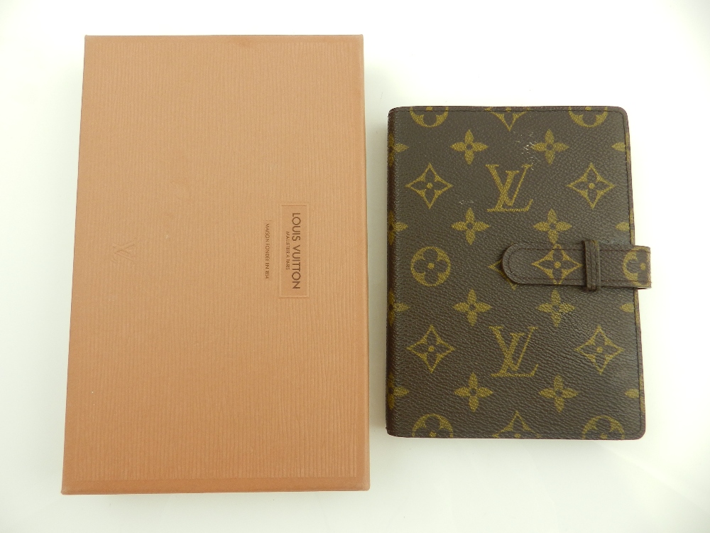 A Louis Vuitton brown monogrammed leather photograph album with plastic sheaths, in original box.