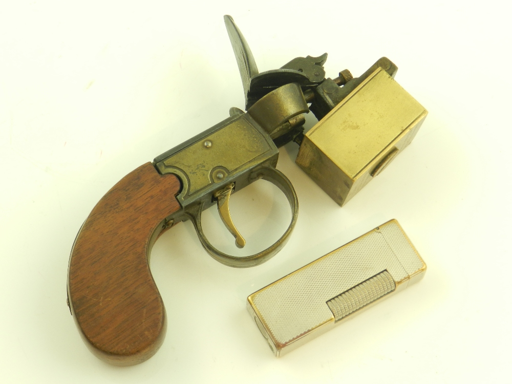 A Dunhill 'Tinder Pistol' table lighter, PAT, 19273/34, Reg. 794093, and an engine turned Dunhill