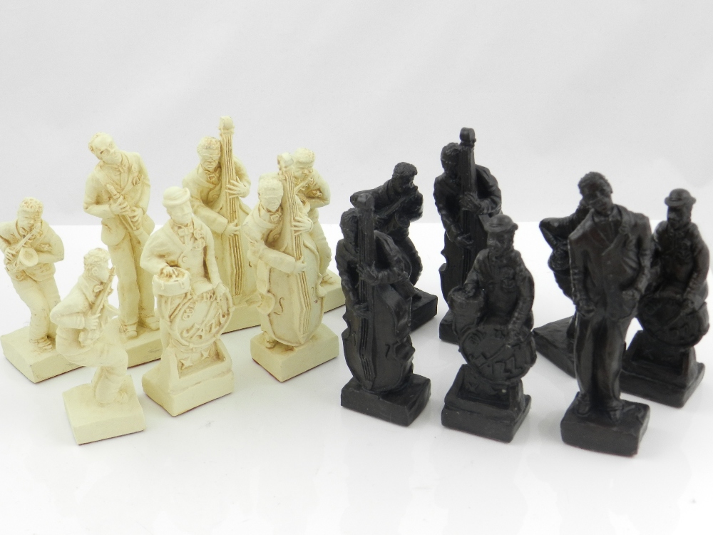 A chess set in the form of jazz band musicians, colours of brown and cream.