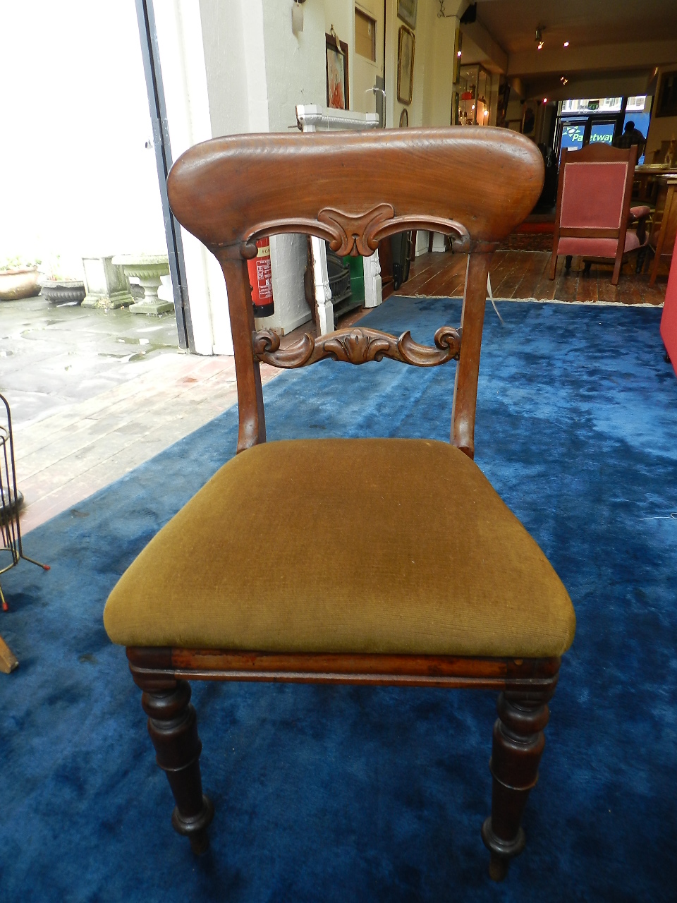 Two occasional chairs upholstered in amber-hued velour.