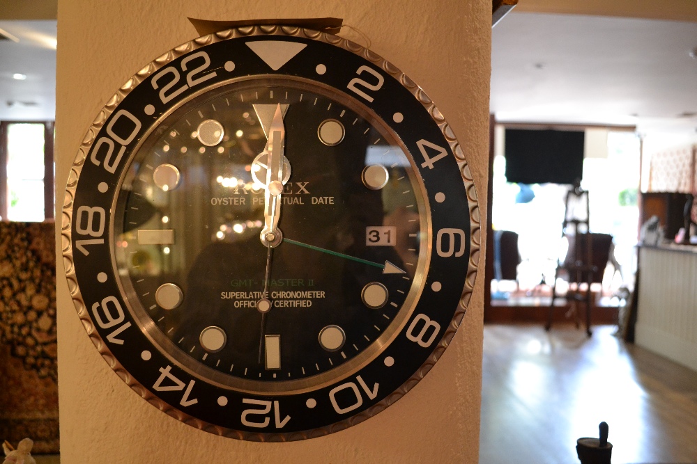 A Rolex style dealers display clock of circular form