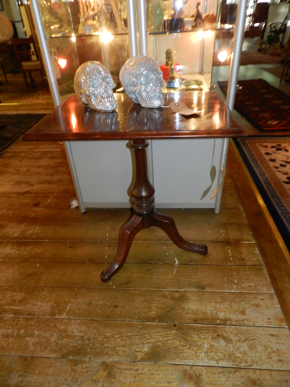 A 19th century mahogany pedestal table of rectangular form on tripod out swept supports.