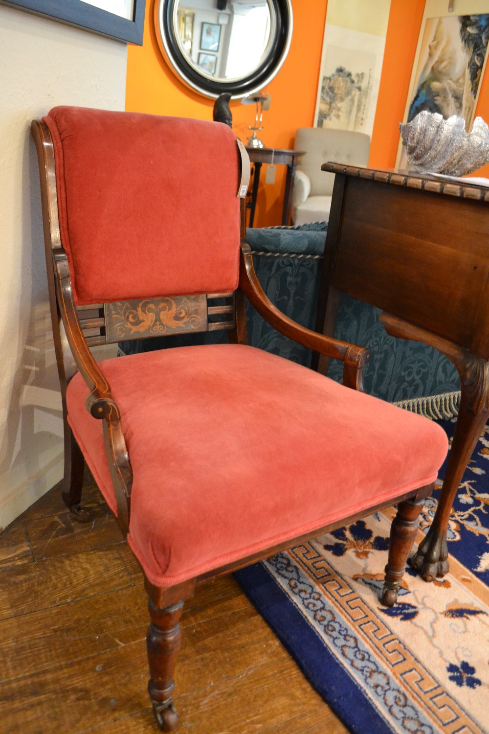 A late Victorian marquetry inlaid rosewood open elbow library chair having upholstered back rest and