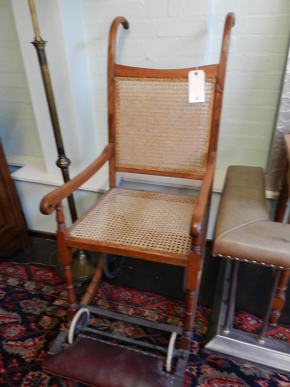 A fruitwood framed invalid porters chair having carved back rest and seat.