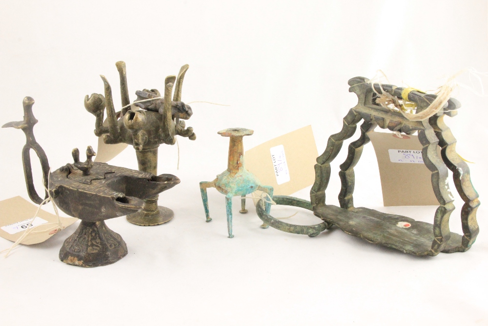 Antique Indian bronze stirrups, an oil lamp, two bronze "make-up" vessels and a cast lion.