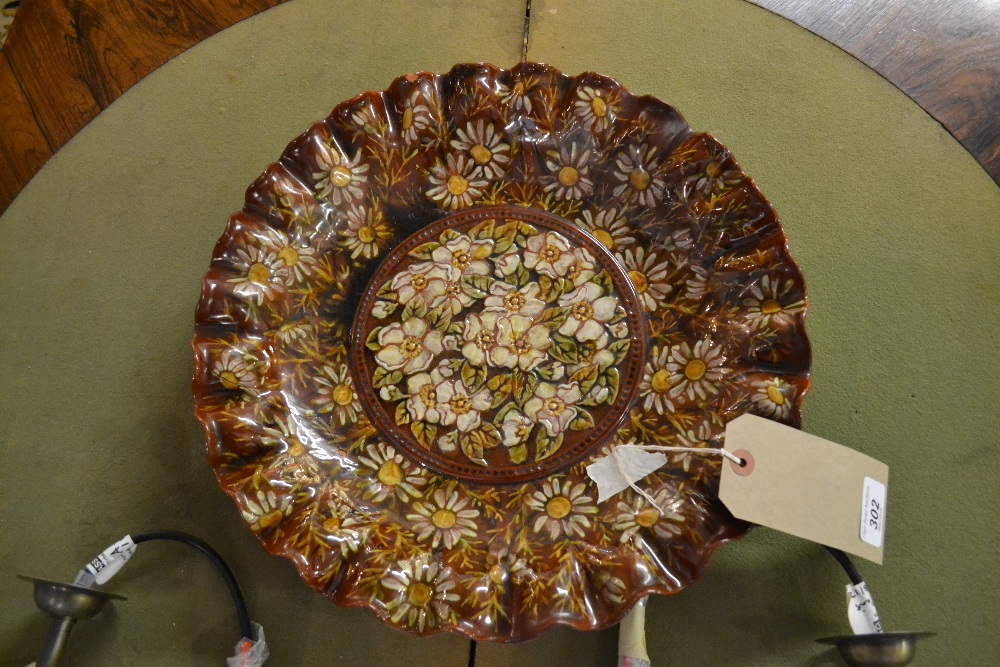 A Linthorpe pottery Christopher Dresser design charger of scalloped form all over decorated with