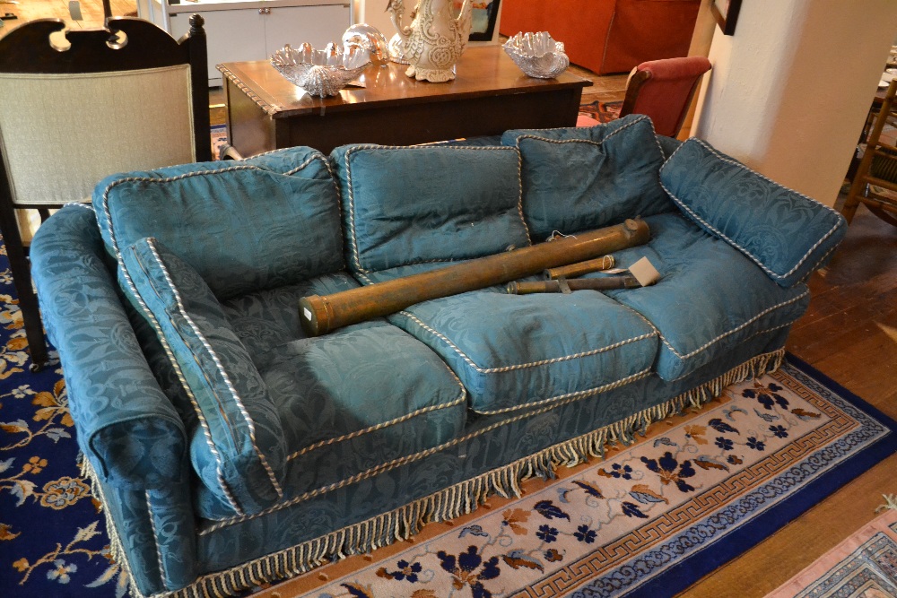 A contemporary three seater sofa upholstered in a classical stitched blue fabric.
