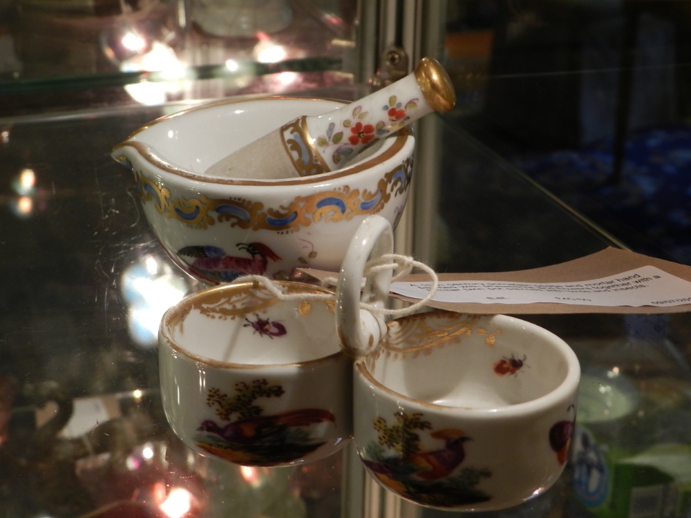 A 19th century porcelain pestle and mortar hand painted with pheasants and flowers together with a