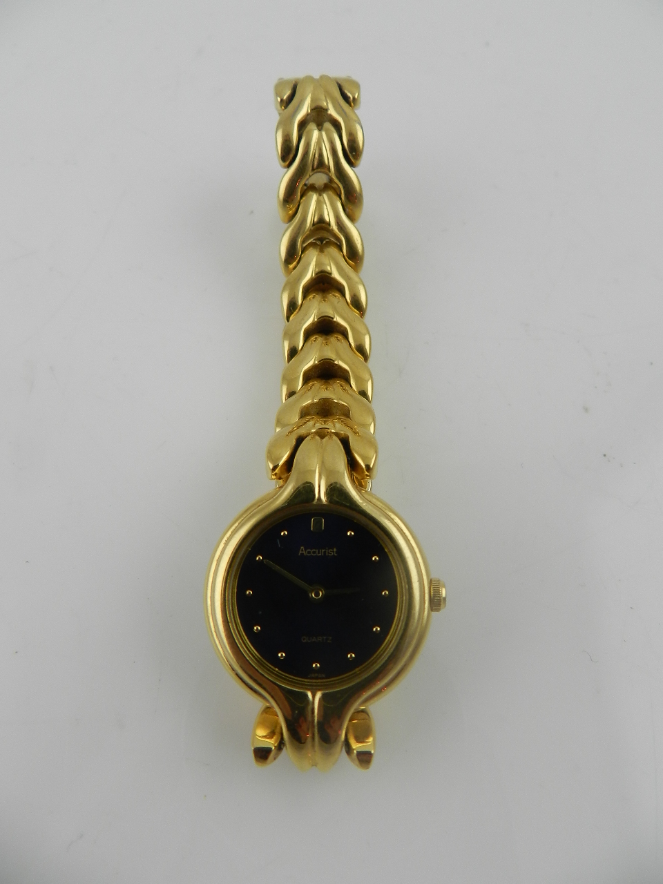 A ladies accurist gilt metal cased dress watch having black dial.