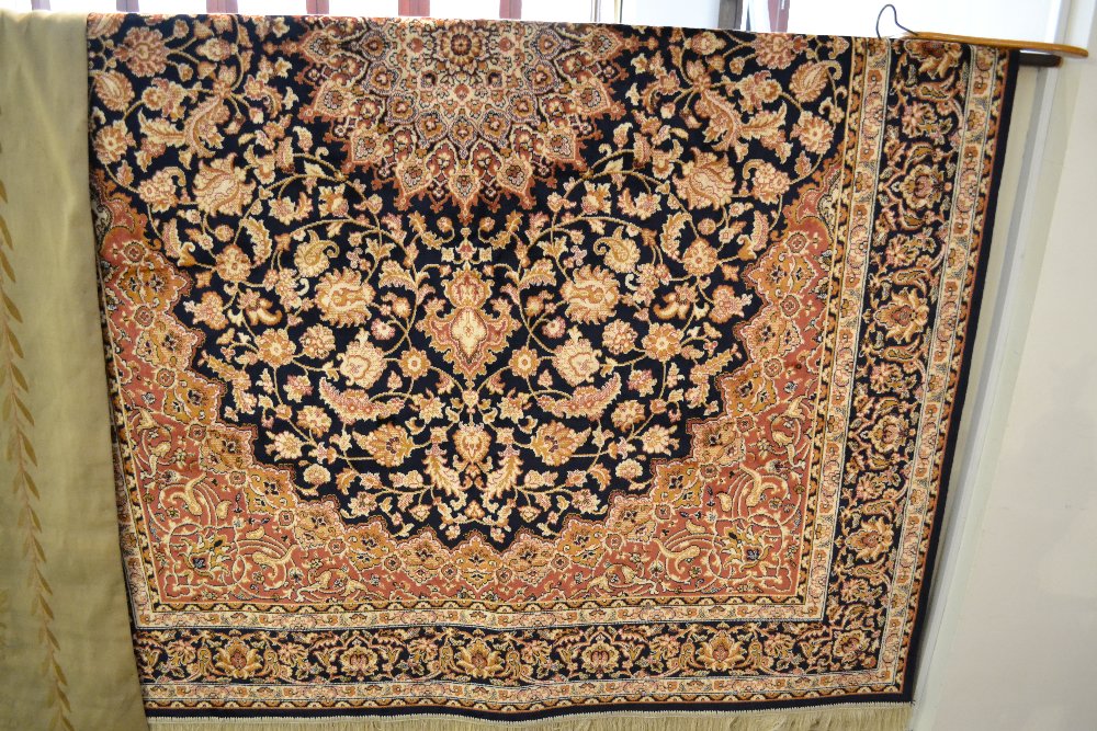 A Keshan style rug having central medallion on a floral blue ground contained by border. 230 x 160.