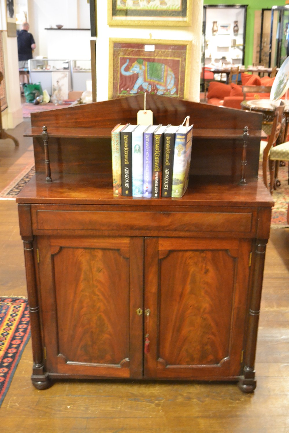 A Victorian mahogany chiffonier having shelved gallery above frieze drawer and two panelled doors