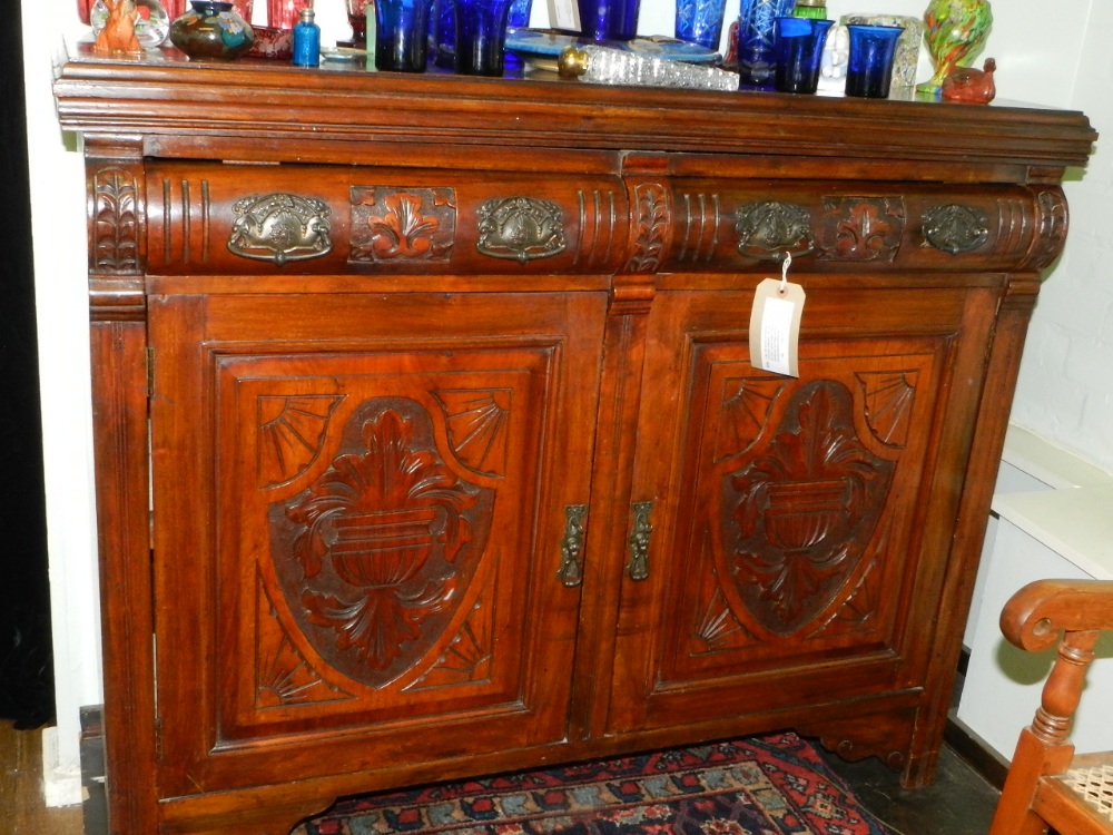 A late 19th century continental mahogany rectangular sideboard, the plain moulded top above two