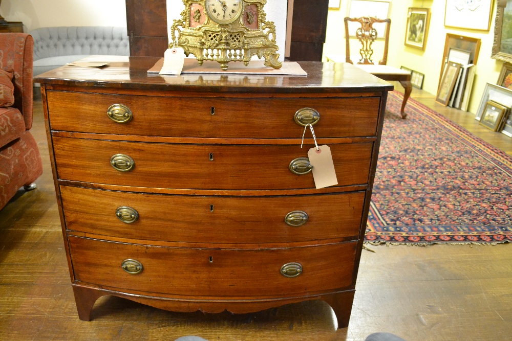 A 19th century inlaid and cross banded mahogany bow fronted chest of three long graduated drawers