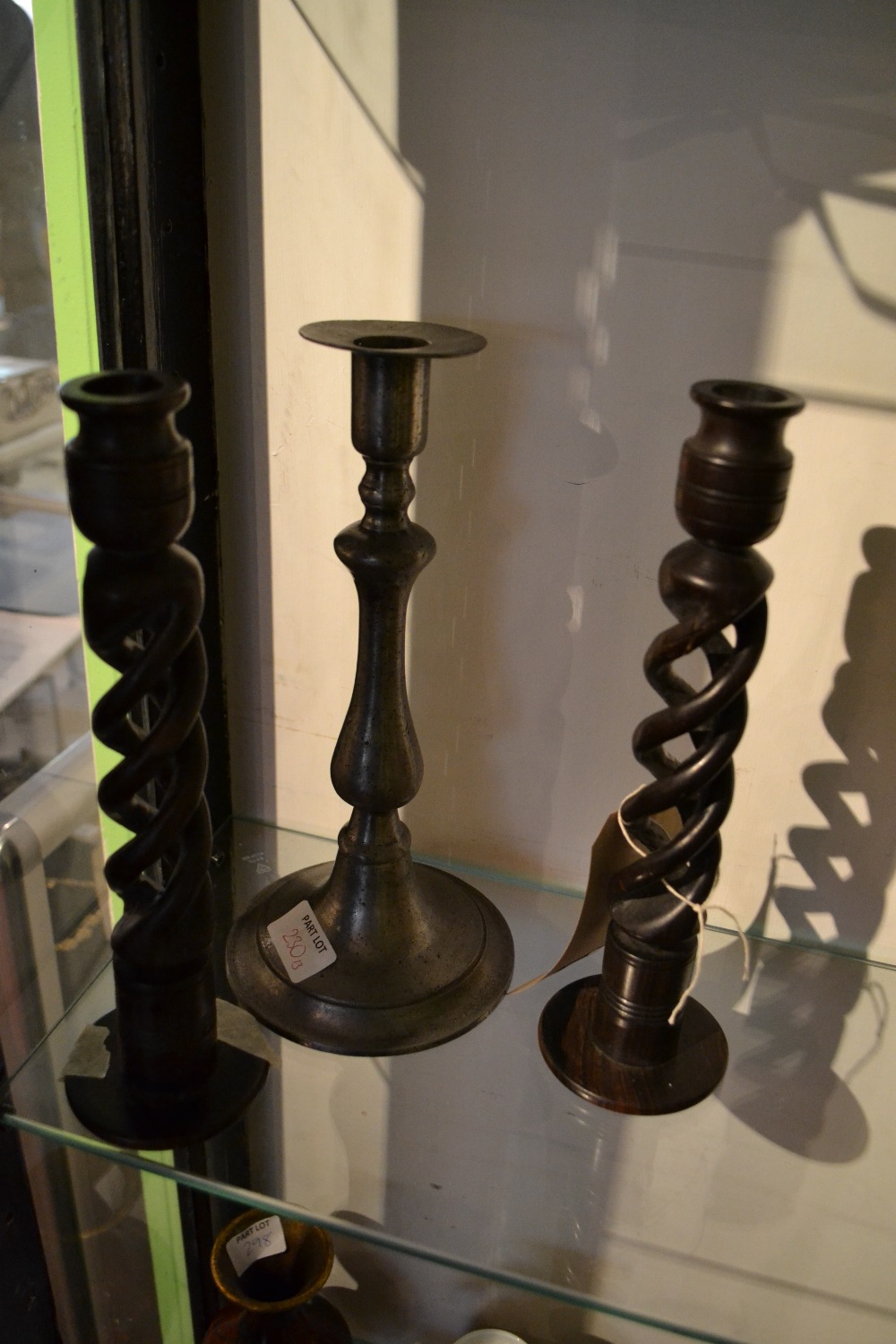 A pair of treen pierced barley twist candle holder together with a pewter example