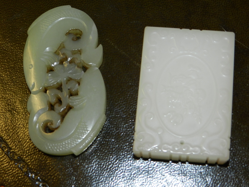 A Chinese carved jade pendant of rectangular  form together with one other pierced pendant of tin