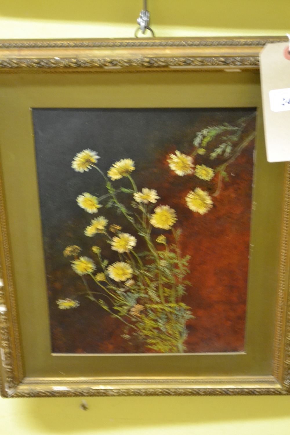 A framed oil on panel of yellow flowers.