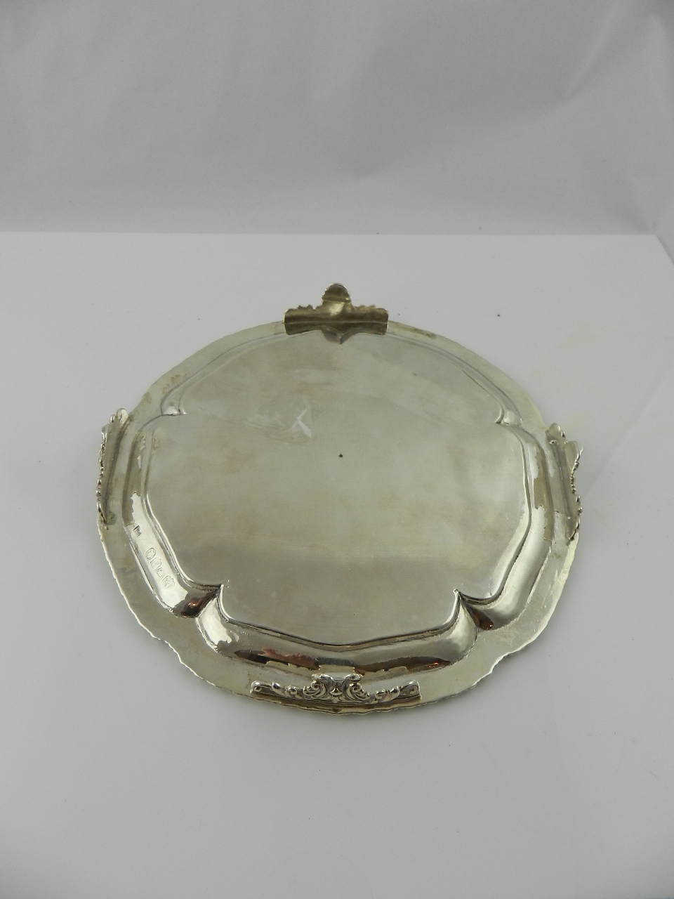 A Georgian hallmarked silver card tray raised on four scroll feet