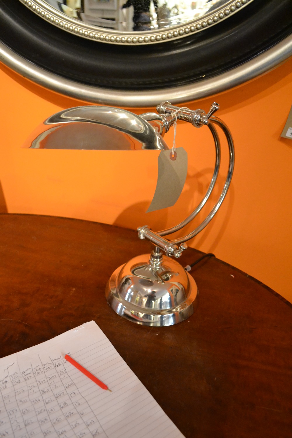 An Art Deco style adjustable table lamp of arc form raised on a domed base.