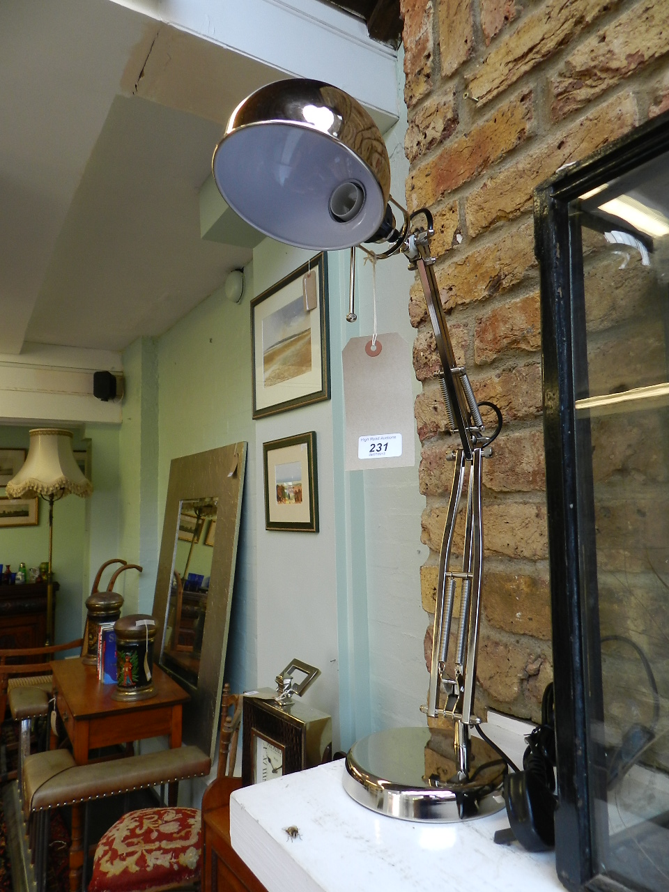 A pair of chrome angle poise desk lamps.