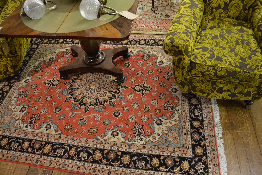 A fine North West Persian rug having central organic medallion on a floral terracotta ground