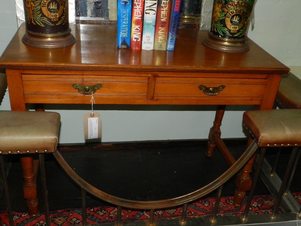 An early 20th century plain rectangular side table having two drawers with brass swing handles on