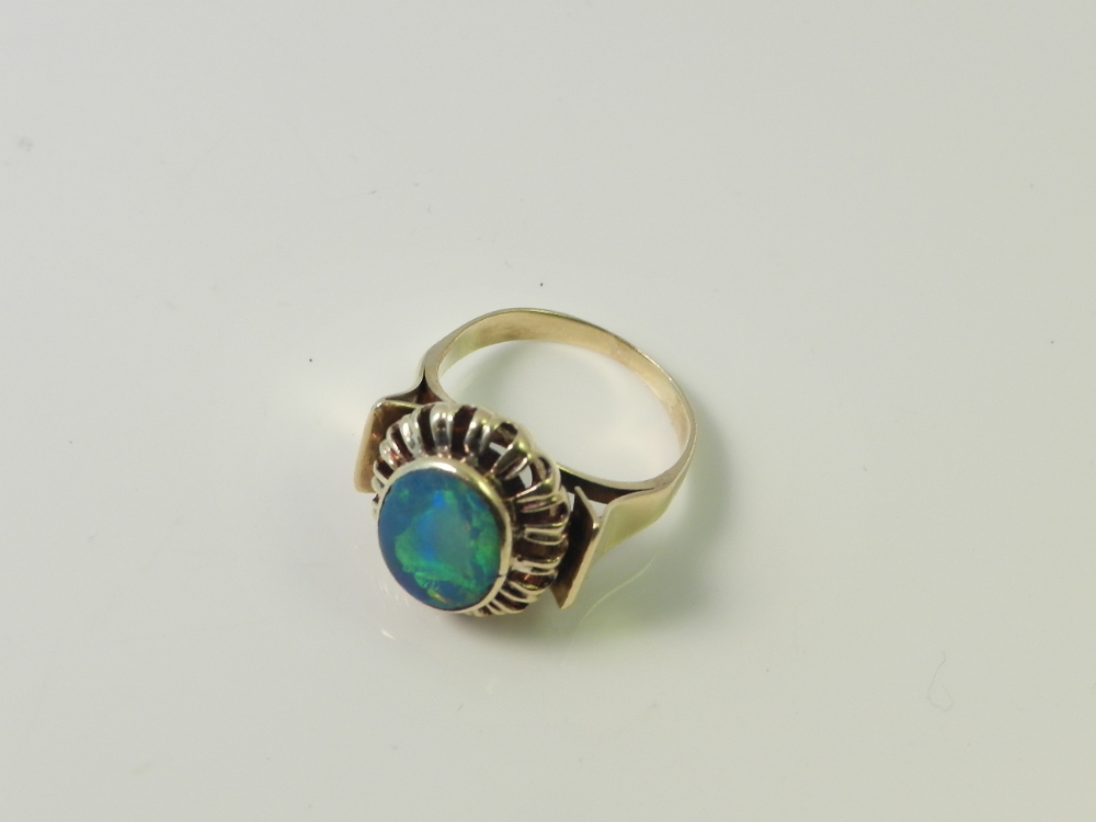 An 18ct gold mounted black opal ladies dress ring. Size O.