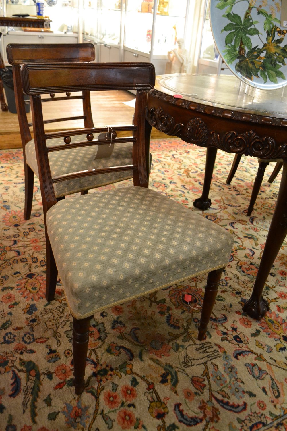 Four 19th century mahogany upholstered dining chairs having reeded back splats three rails divided