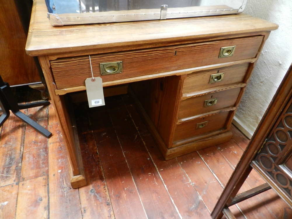 A pitch pine desk having an arrangement of four drawers.