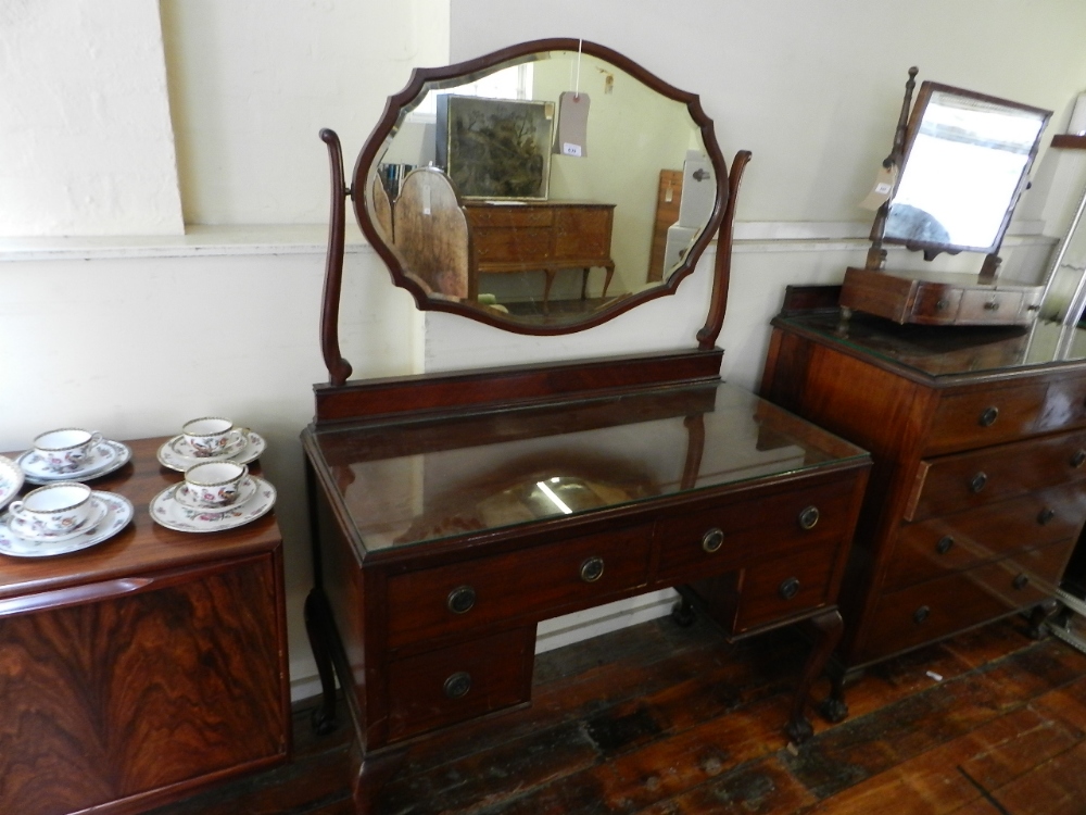 A mahogany mirror backed dressing table of four drawers together with a matching chest of two