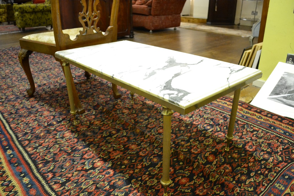 A marble topped low table raised on a gilt metal base