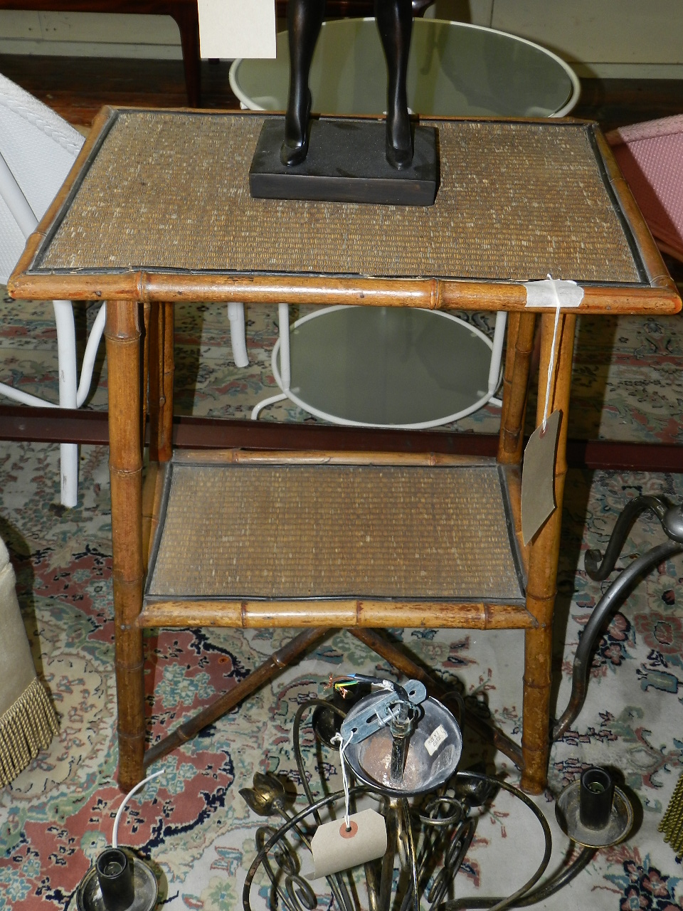 A rattan topped bamboo occasional table of two tiers.