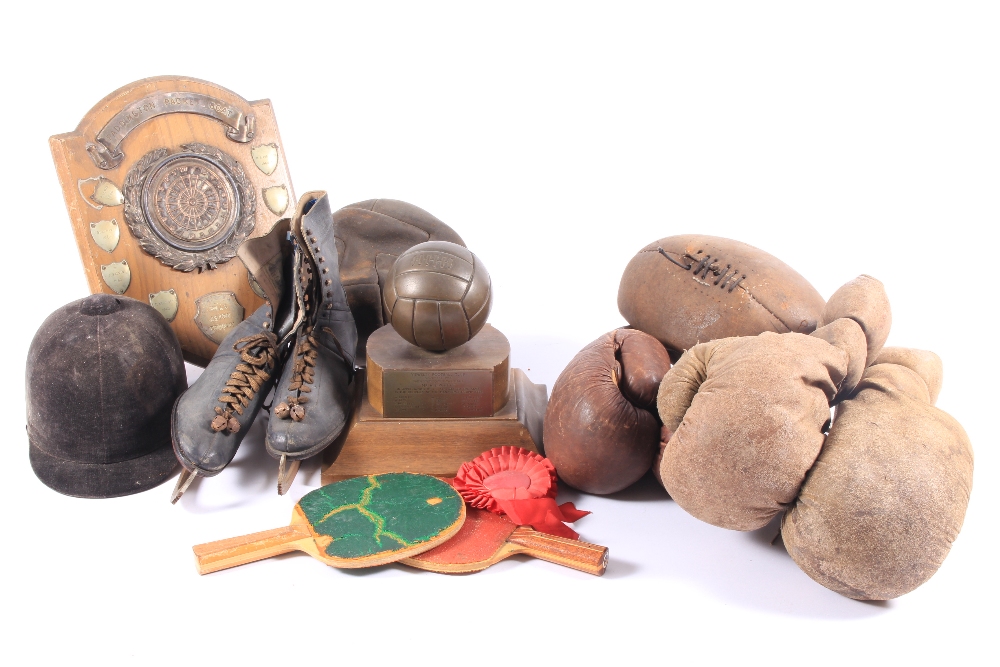 A large collection of antique/vintage leather boxing gloves, trophies and related items.