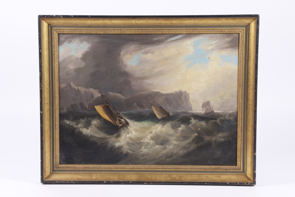 A gilt framed early 19th century oil on canvas seascape of ships tossed in a stormy sea below a dark