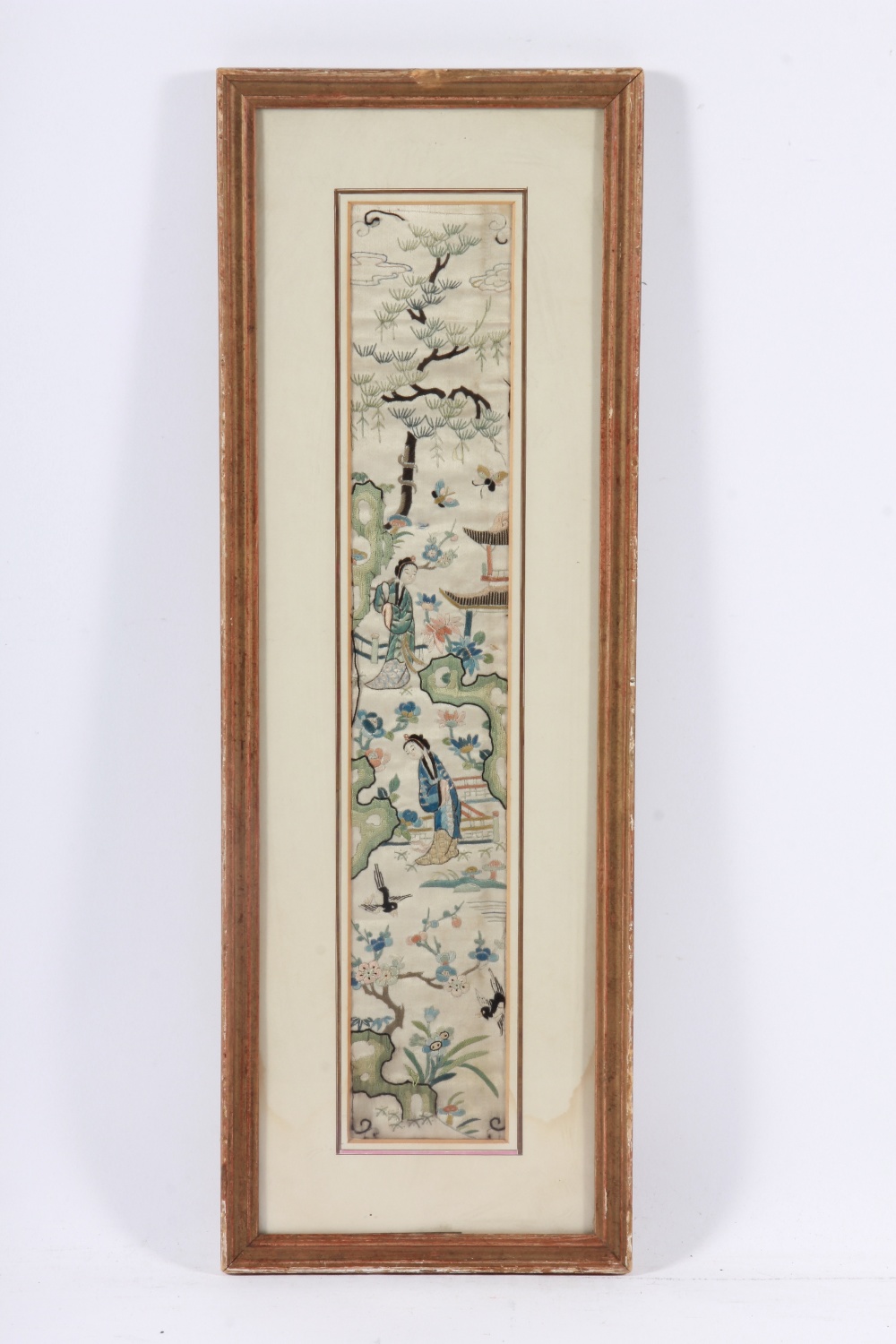 A framed and glazed oriental rectangular embroidery on silk of courtesans in a garden with birds and
